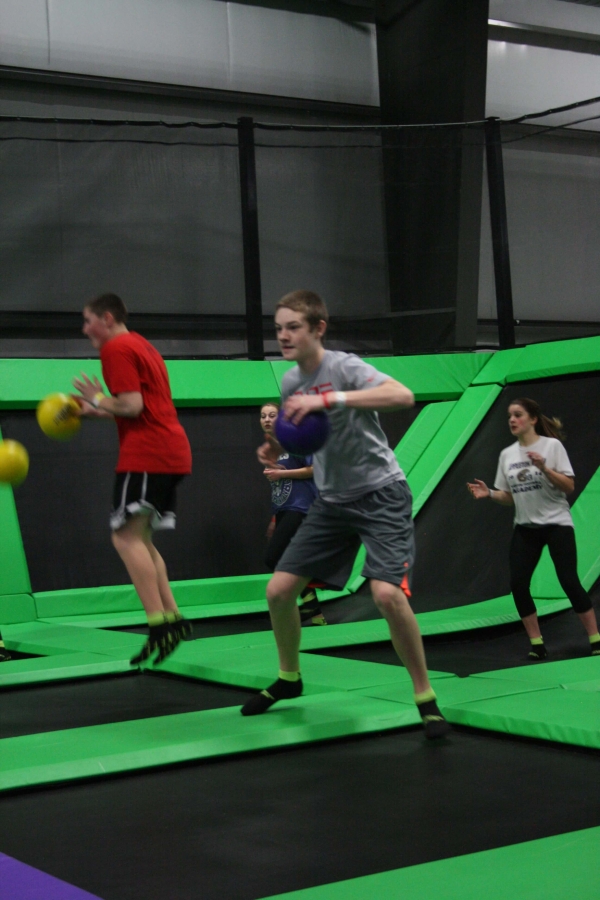 Two Boys and Two Girls Playing Trampoline Dodgeball on a Team